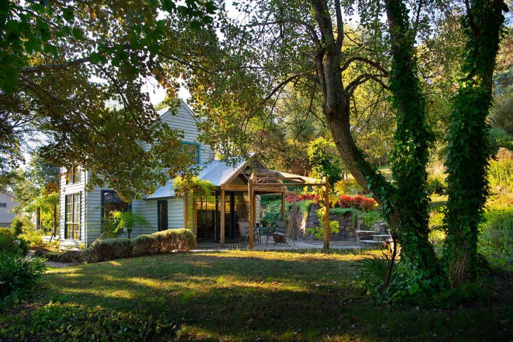 a house with a gazebo in a yard at Storybook Cottage-surrounded by beautiful gardens in Daylesford