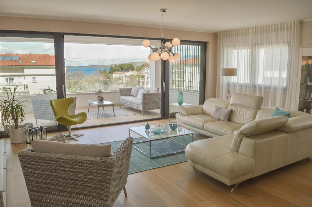 a living room with a couch and a table at Rova Apartment in Malinska