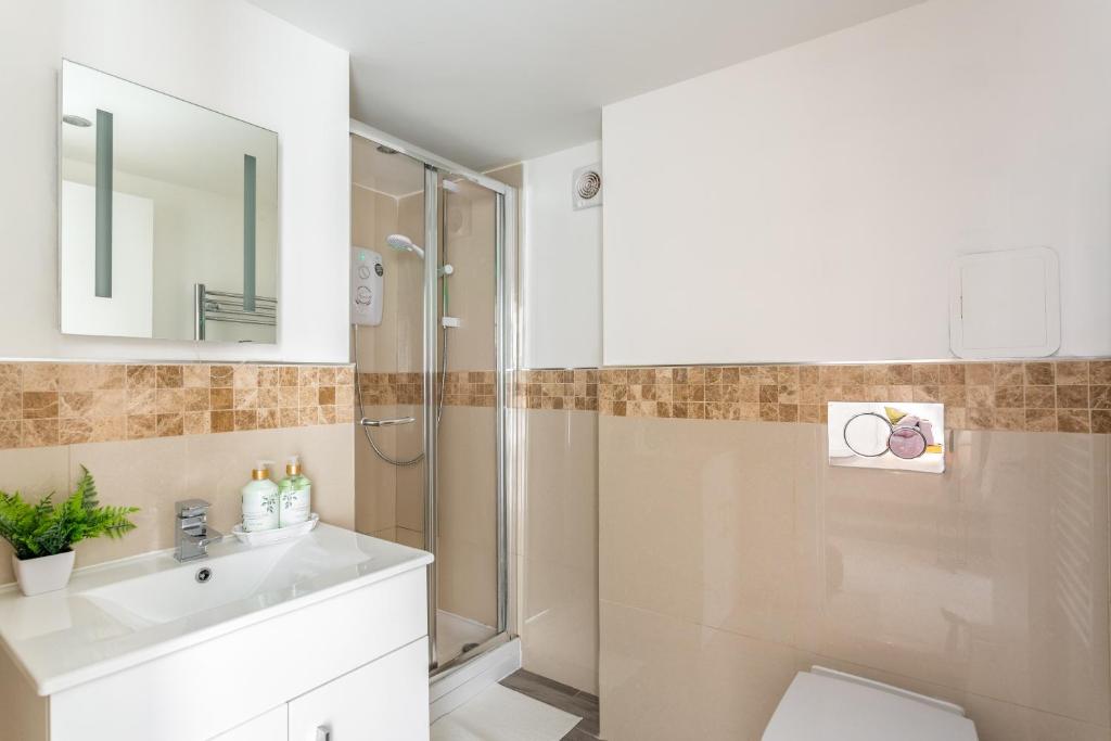 a bathroom with a shower and a sink at East Street Apartments, The Lanes Brighton in Brighton & Hove