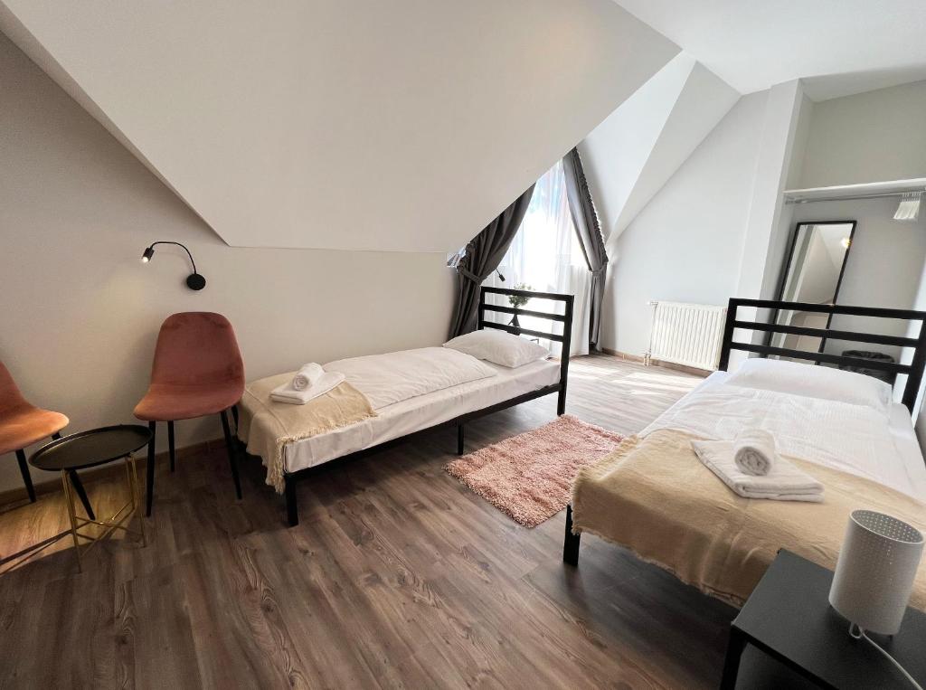 Postel nebo postele na pokoji v ubytování Nussbaum Panzió