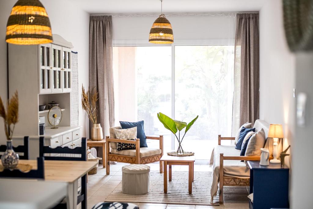 a living room with a large window and a couch at Blue Nest at Mandria Gardens in Mandria