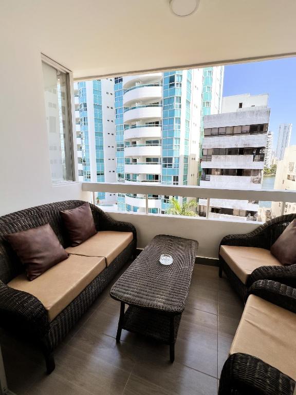 a living room with two couches and a large window at Polanco Residences Tocagua Cartagena - Colombia in Cartagena de Indias
