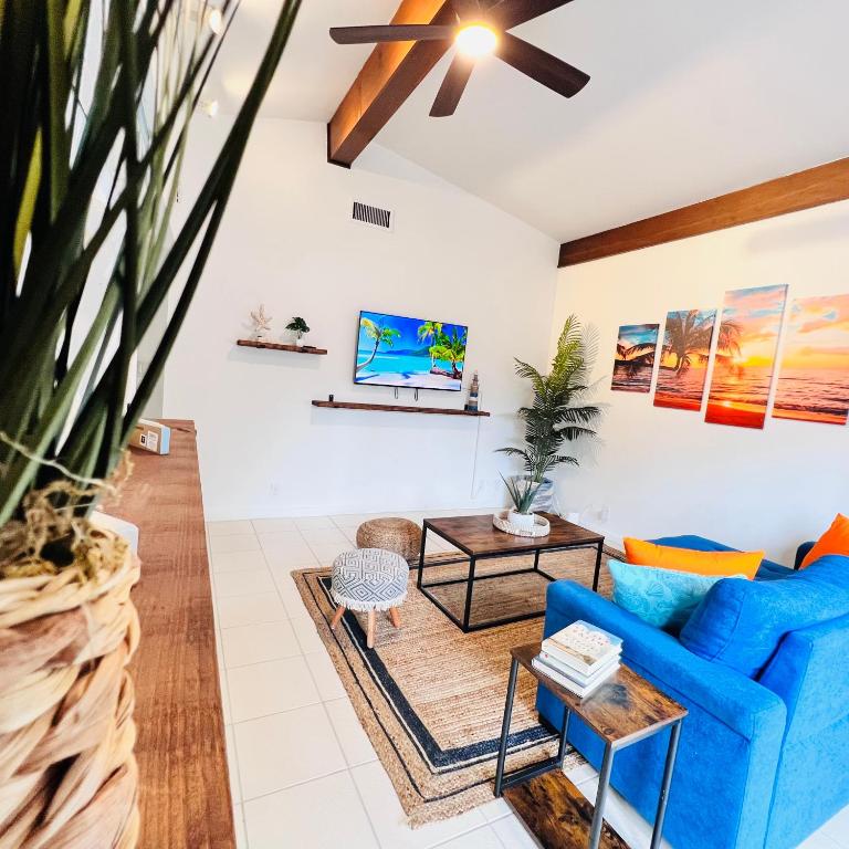 a living room with a blue couch and a table at CocoBay 2BR Condos Near Beach, Galleria Mall, Wilton Manors, Cruise Port in Fort Lauderdale