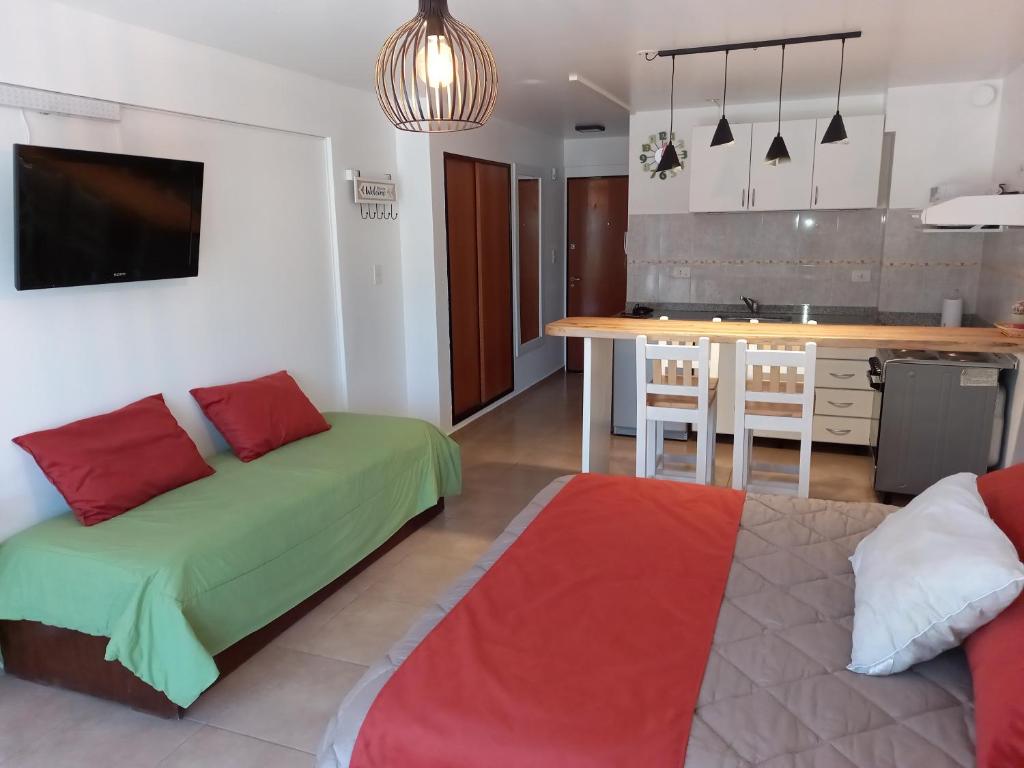a living room with a bed and a kitchen at Bariloche Dreams in San Carlos de Bariloche