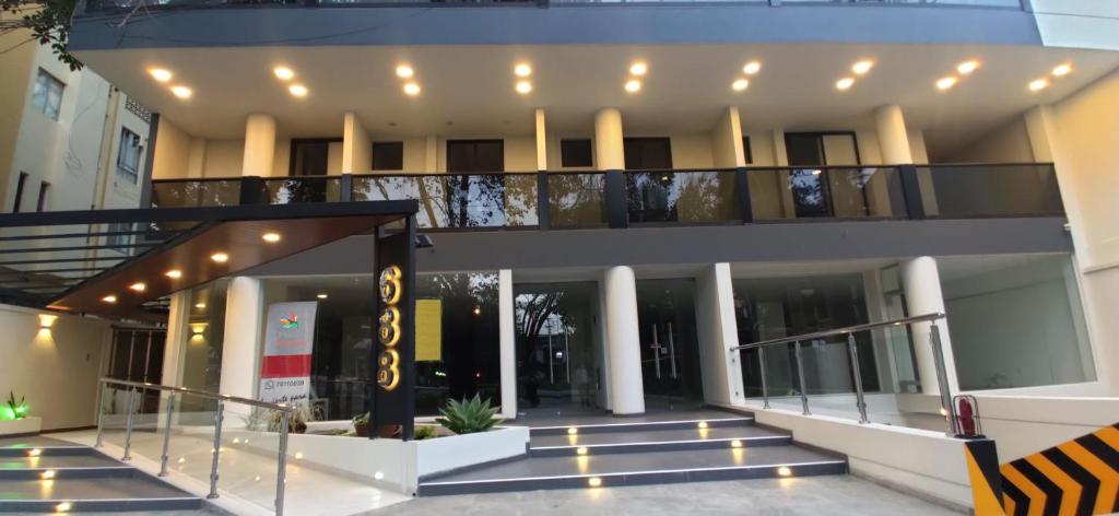 a building with a balcony with lights on it at Departamento moderno, familiar y acogedor. in Cochabamba