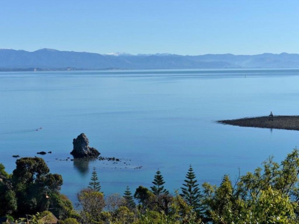 a large body of water with a rock in it at Studio or Cabin on Whitby in Nelson