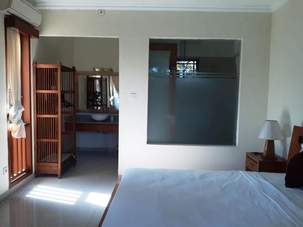 Postel nebo postele na pokoji v ubytování Manggis Sari Guesthouse