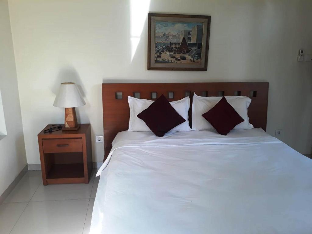 Postel nebo postele na pokoji v ubytování Manggis Sari Guesthouse