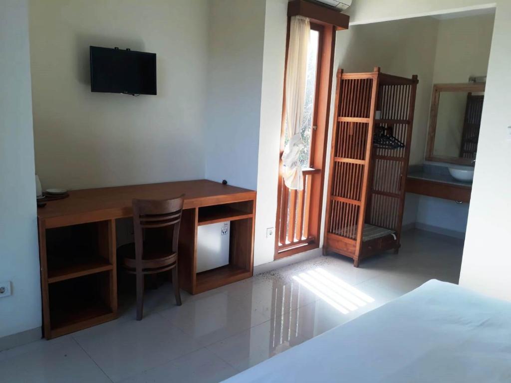 TV a/nebo společenská místnost v ubytování Manggis Sari Guesthouse