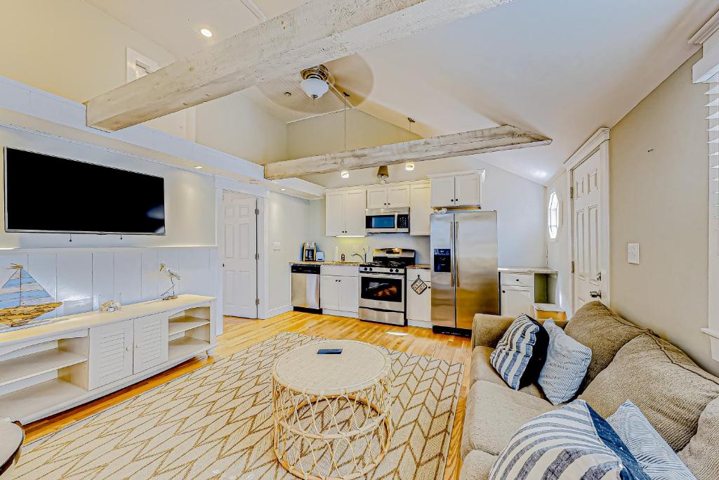 a large living room with a couch and a kitchen at Salty Kisses Main in Yarmouth