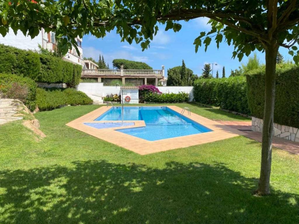 a swimming pool in the yard of a house at Casa Blanca 42 – Piscina, BBQ y Wifi (5 pax) in Tossa de Mar