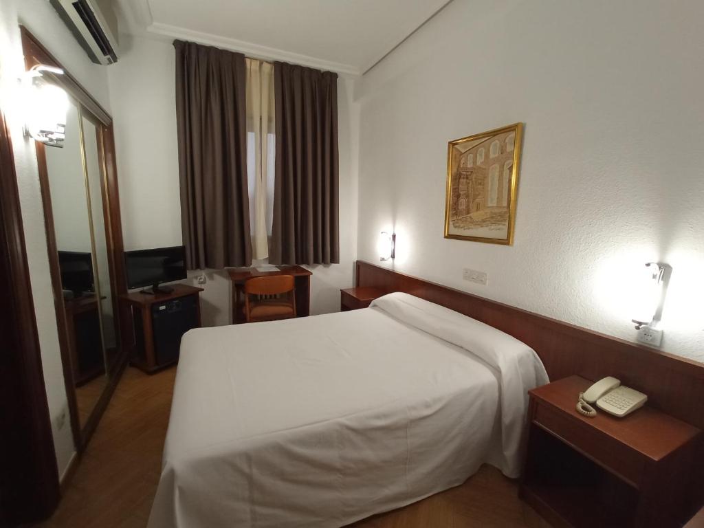 Postel nebo postele na pokoji v ubytování Hotel ELE Acueducto