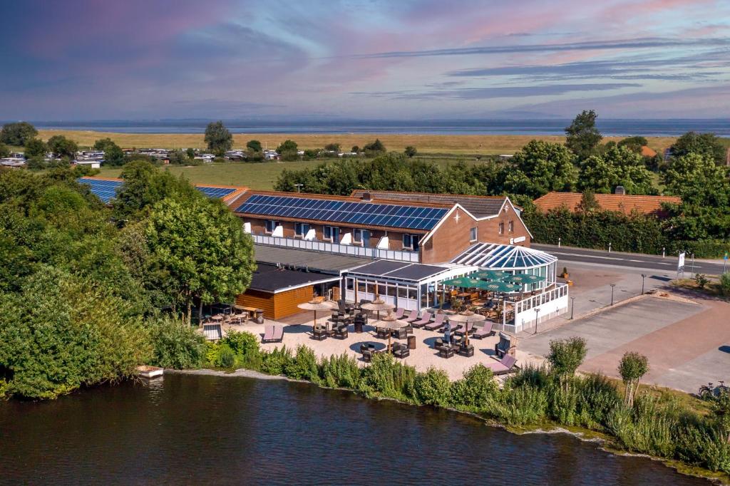 an aerial view of a building next to a river at Hotel Nordstern in Neuharlingersiel