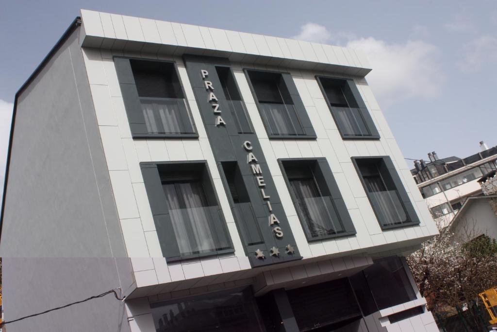 a building with a sign on the side of it at Praza Camelias in Sarria