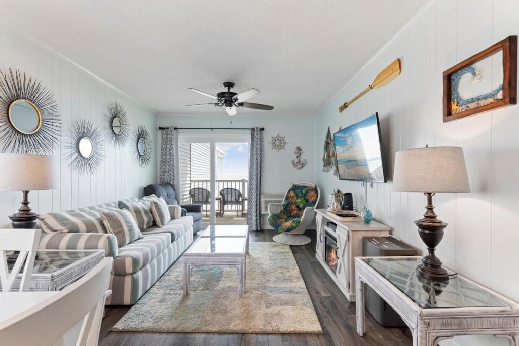 a living room with a couch and a table at Bright and Sunny Condo with Stunning Oceanfront in Myrtle Beach