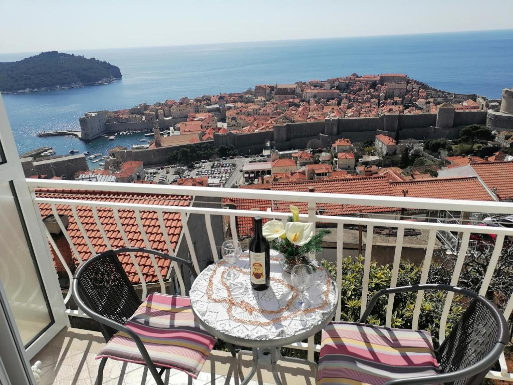 a table with a bottle of wine on a balcony at Guest House Blaise in Dubrovnik