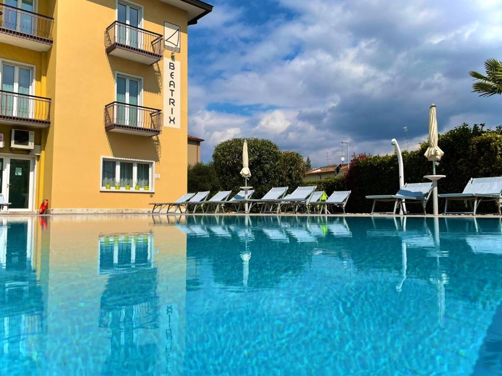 a large swimming pool in front of a hotel at Residence Beatrix in Bardolino