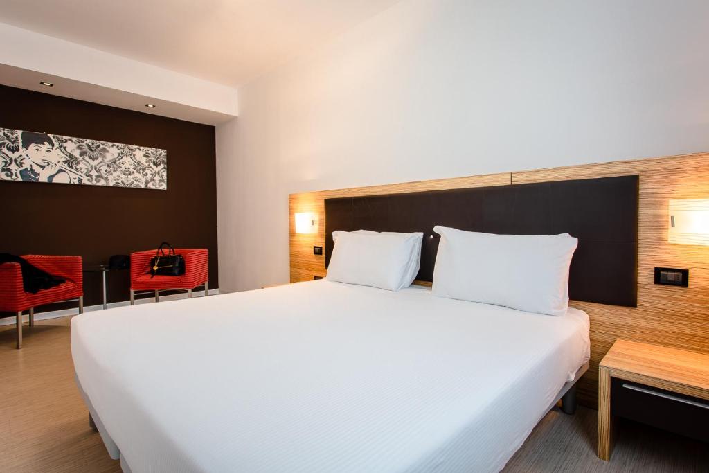 Postel nebo postele na pokoji v ubytování Hotel Ambra