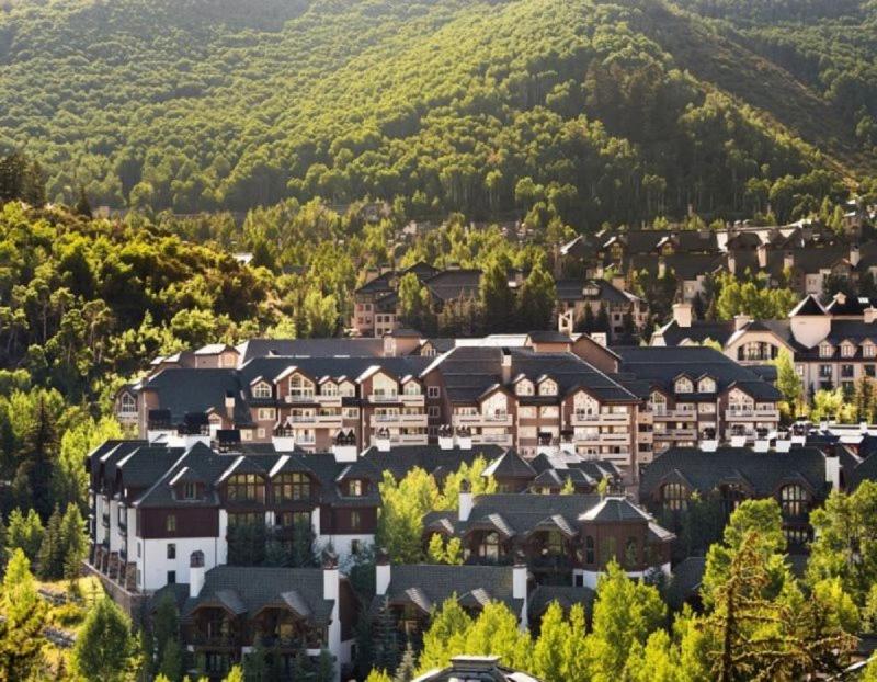 a group of houses in a town with a mountain at Ski, In Ski Out 3 Bedroom Vacation Condo With Resort Amenities That Include Exercise Center, Indoor Pool, And Hot Tubs in Beaver Creek