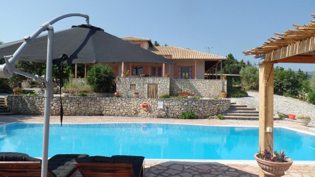 a villa with a swimming pool and a house at Lefkada Seaview Villa in Lygia