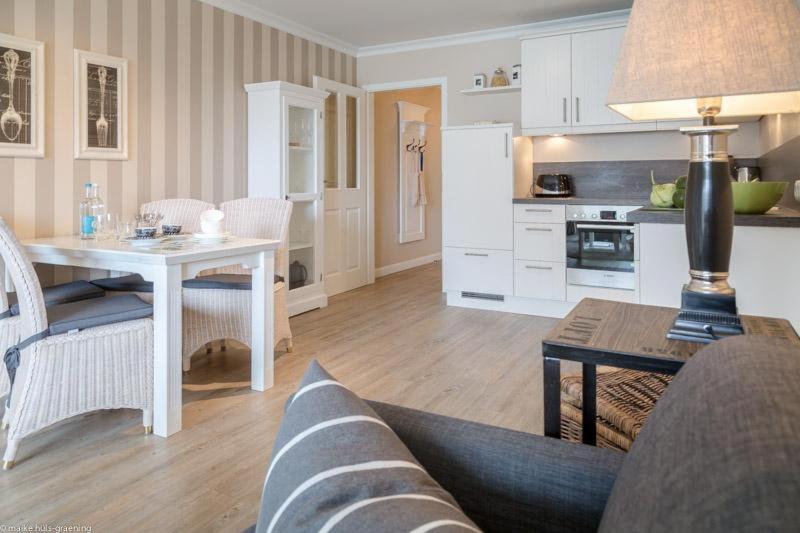 a living room with a couch and a table and a kitchen at Vik6 9 Viktoria Residenz in Westerland (Sylt)