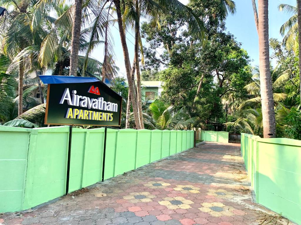 a sign for an apartment atthanandan apartments on a fence at Airavatham Apartments in Guruvāyūr