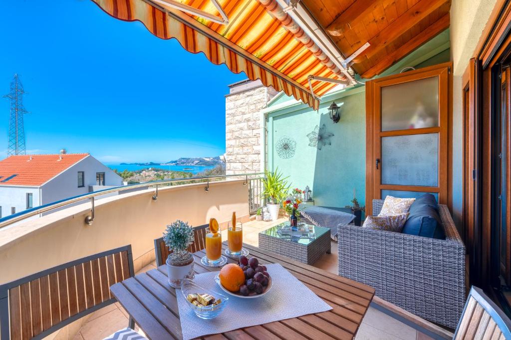 a balcony with a table with fruit on it at Penthouse Apartment Marija in Cavtat