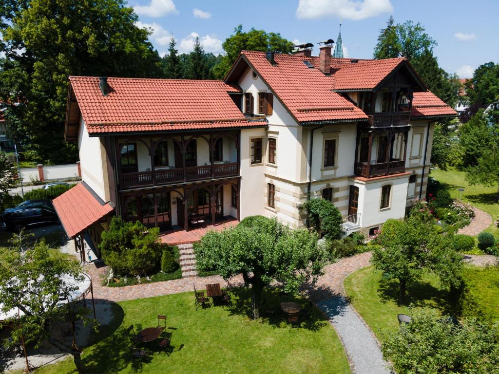 an aerial view of a house with red roof at Villa Fantasia Budget Boutique Hotel in Füssen