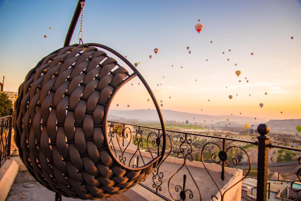 a view from a balcony with hot air balloons in the sky at Simera in Cappadocia - Special Class in Uçhisar