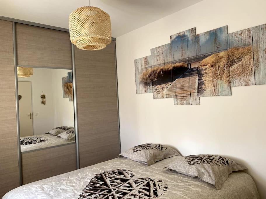 a bedroom with a bed and a painting on the wall at Une Oasis au Pays de Cézanne in Aix-en-Provence