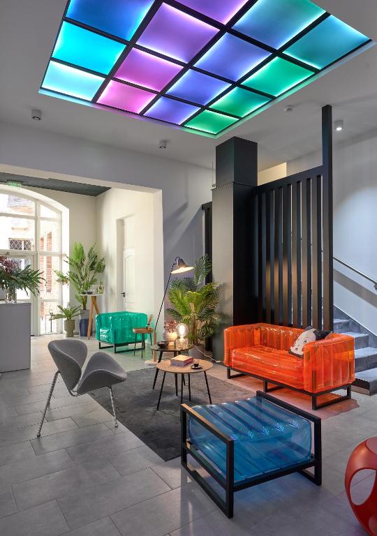 a living room with a couch and a table at Butik Art Hotel in Budapest