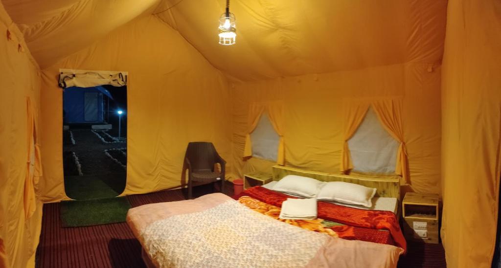 a bedroom with two beds in a tent at Baspa Valley Adventure Camp in Saturang