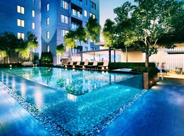 a swimming pool in front of a building at Summer suites klcc by Star Residence in Kuala Lumpur