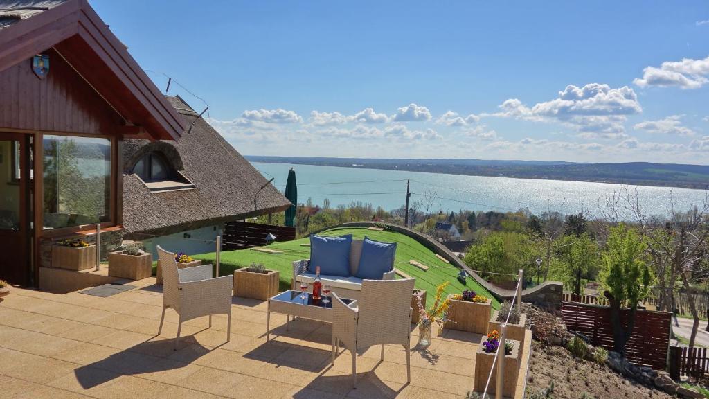 a patio with chairs and a playground with a house at Ferenc Vendégház in Tihany