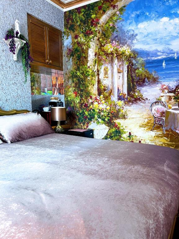 a bedroom with a painting of a garden at The Mirador Boutique Town House in Swansea