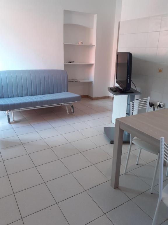 a waiting room with a blue bench and a tv at Casetta Oasi Campo ai Peri in Casa Marchetti