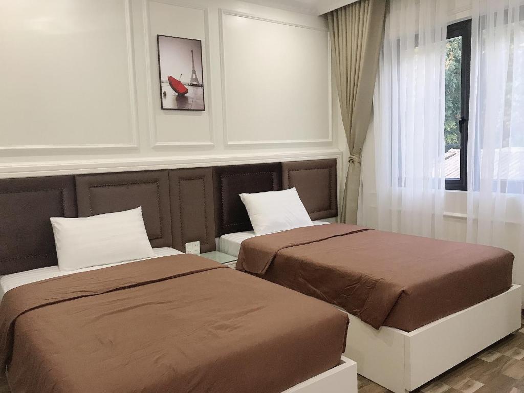 Ένα ή περισσότερα κρεβάτια σε δωμάτιο στο Lynh's Villa