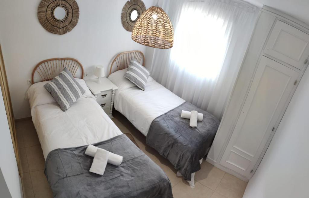 Łóżko lub łóżka w pokoju w obiekcie Apartamento El Capacho
