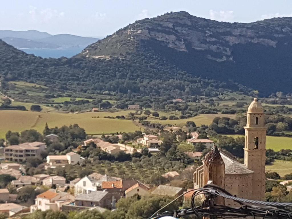 una vista de una pequeña ciudad con una torre de reloj en villa bana en Patrimonio