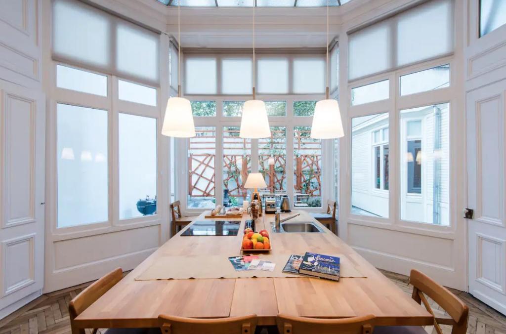 a large dining room with a large wooden table with chairs at VIEUX LILLE Porte de Gand Bienvenue chez NESTYOU, Lille in Lille