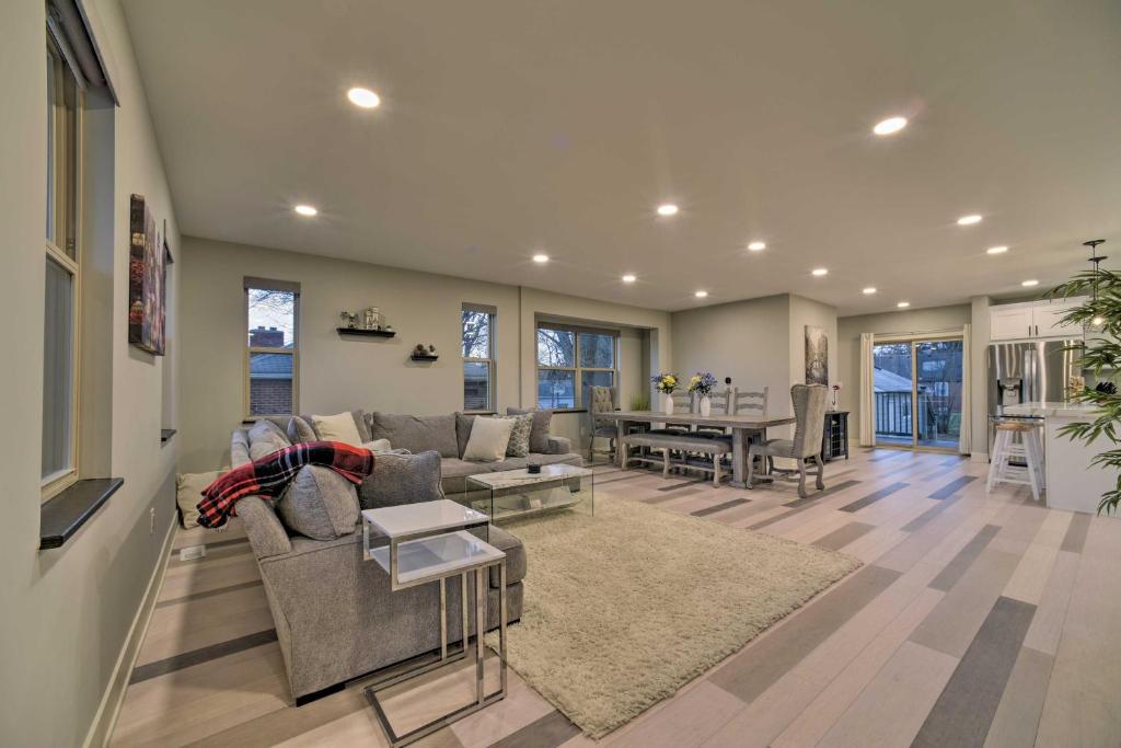 a living room with a couch and a table at Sunny Clawson Home with Yard - Walk to Main St! in Clawson