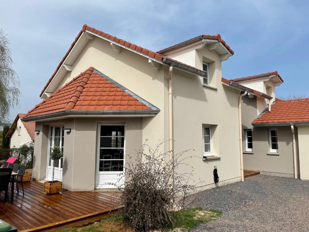 a white house with a wooden deck at Le boudoir in Épinal