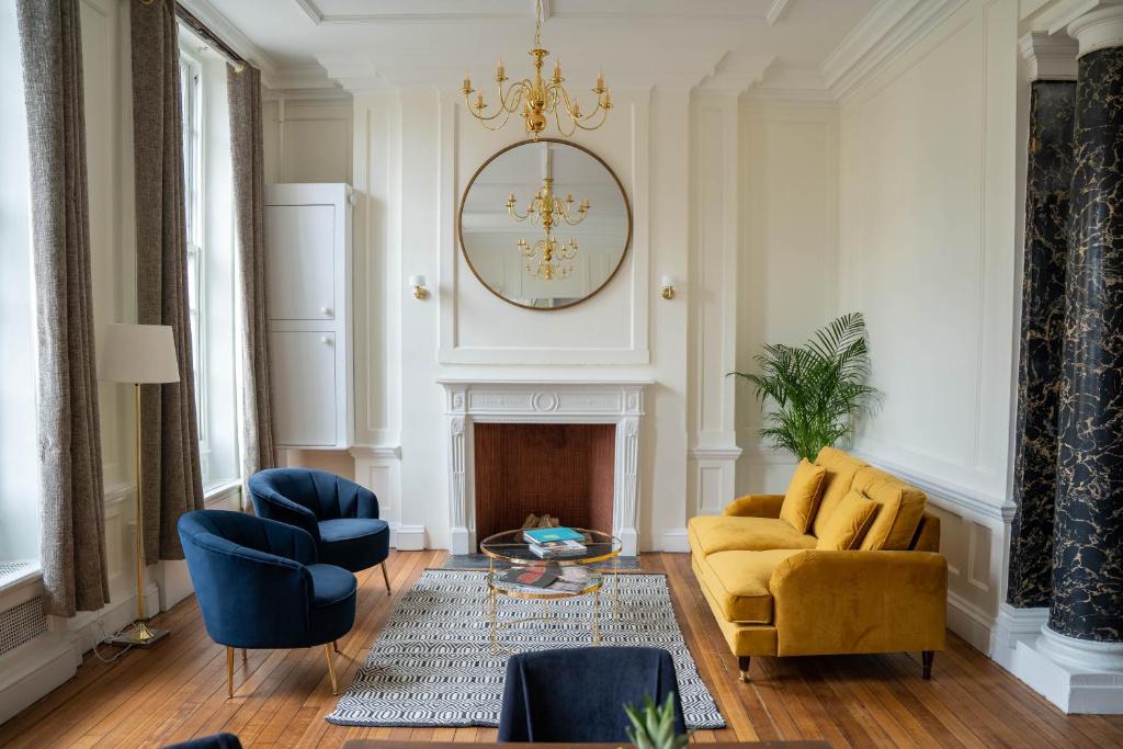 a living room with a couch and chairs and a chandelier at Charrington House in London