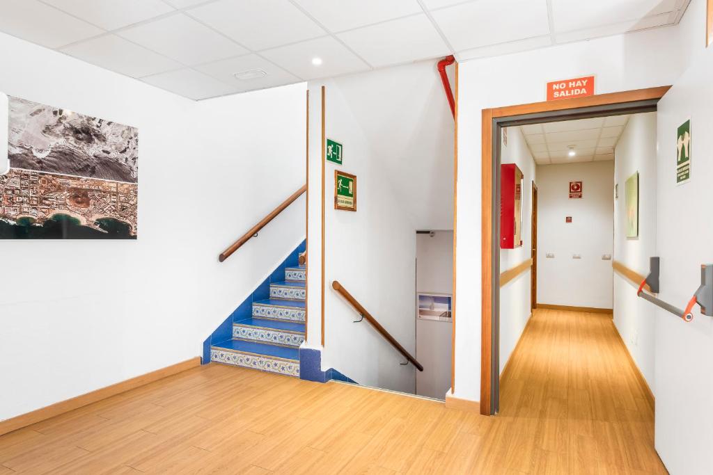 a hallway with blue stairs in a building at Hotel Andrea´s in Los Cristianos