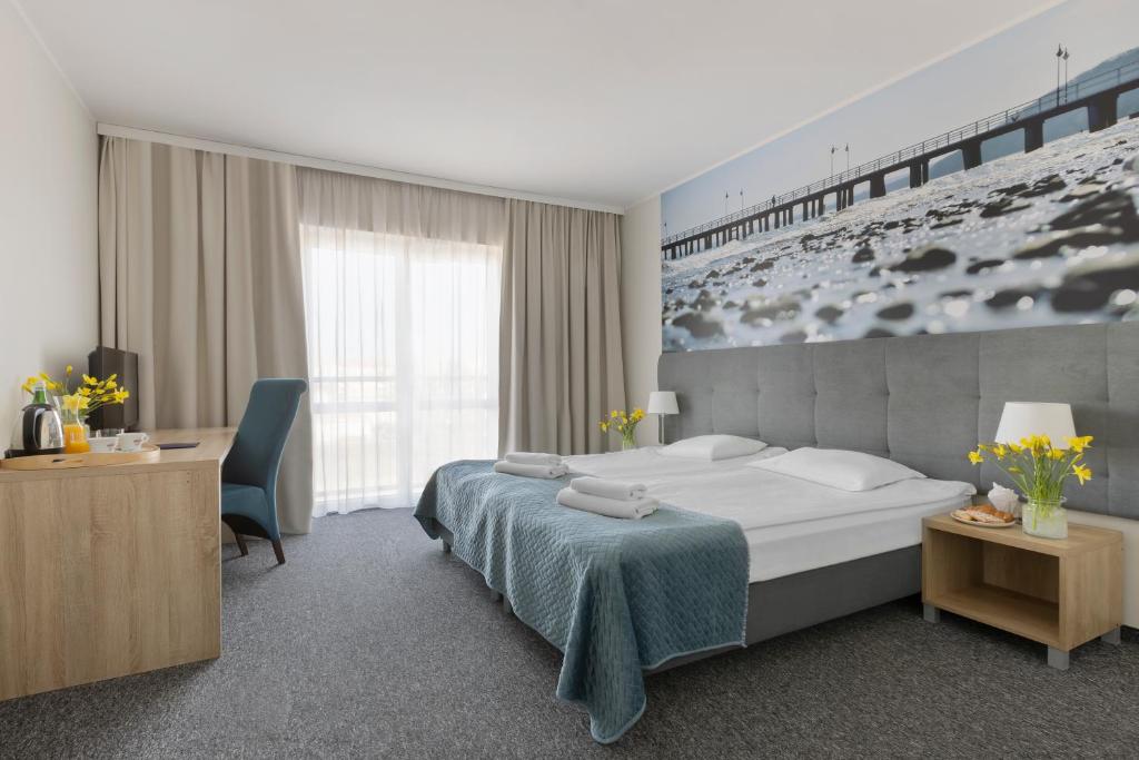Łóżko lub łóżka w pokoju w obiekcie Baltic Hotel