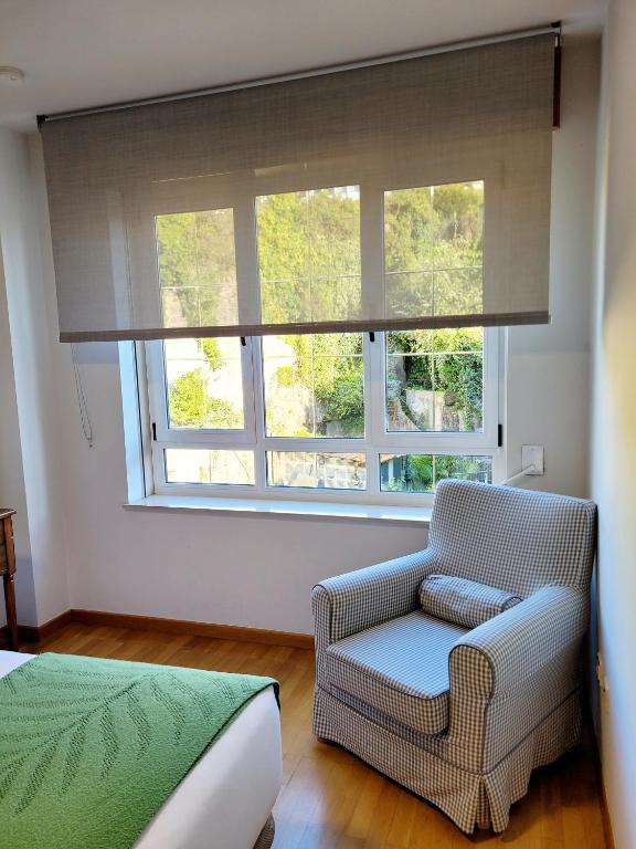 A bed or beds in a room at Piso con garaje en la entrada del camino portugués