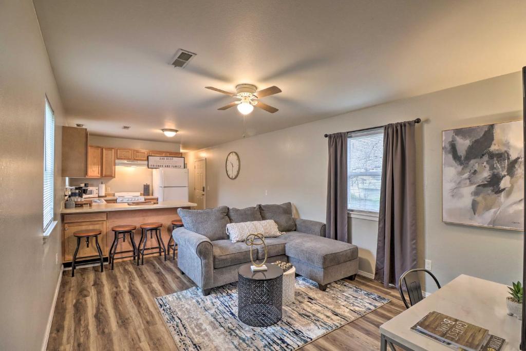 a living room with a couch and a kitchen at Cozy West Plains Home Near Shopping and Dining! in West Plains