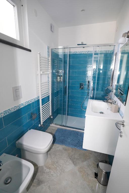 a bathroom with a toilet and a sink and a shower at Casa Astra in Anacapri