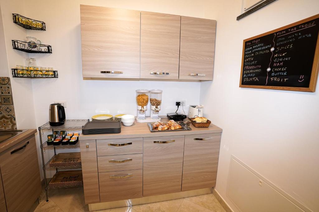 a kitchen with a counter with a chalkboard on the wall at Casa Astra in Anacapri