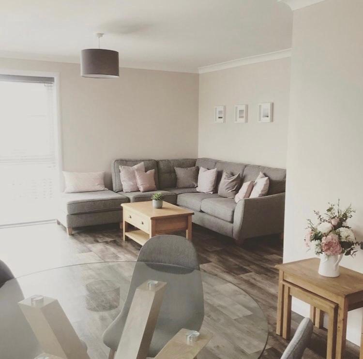 a living room with a couch and a table at Wick Holiday Home - NC500 Route in Wick